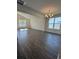 Living room featuring hardwood floors, a modern chandelier, and bright, sun-filled windows at 8663 Farrier Dr., Myrtle Beach, SC 29588