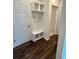 Mudroom area features dark floors and a white storage system with hooks and shelves by the door at 8663 Farrier Dr., Myrtle Beach, SC 29588