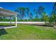 Expansive backyard featuring lush green grass, a white fence, and picturesque views of mature trees at 8667 Farrier Dr., Myrtle Beach, SC 29588