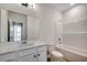 Bright bathroom featuring a tub-shower combo, a white single sink vanity, and a large mirror at 8667 Farrier Dr., Myrtle Beach, SC 29588