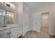 Well-lit bathroom featuring double doors, vanity with drawers, and tile flooring at 8667 Farrier Dr., Myrtle Beach, SC 29588