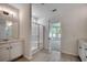 Bright bathroom with a glass-enclosed shower, vanity with drawers, and tile flooring at 8667 Farrier Dr., Myrtle Beach, SC 29588