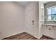 Welcoming entryway features beautiful laminate flooring, white shaker cabinets, and a stylishly tiled backsplash at 8667 Farrier Dr., Myrtle Beach, SC 29588