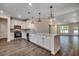 Bright kitchen featuring white cabinets, stainless appliances, wood flooring, and decorative pendant lighting at 8667 Farrier Dr., Myrtle Beach, SC 29588