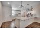 Kitchen featuring stainless appliances, wood flooring, white cabinets, decorative lighting, and eat at island at 8667 Farrier Dr., Myrtle Beach, SC 29588