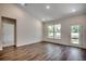 Bright living room featuring vaulted ceiling, wood floors, a bright window view, and a glass panel door at 8667 Farrier Dr., Myrtle Beach, SC 29588