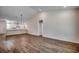 Open-concept living space featuring wood-look flooring and modern pendant lighting over the kitchen bar at 8667 Farrier Dr., Myrtle Beach, SC 29588
