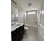 Bright bathroom with a modern vanity, tile flooring, and a tub-shower combo, offering a clean and functional space at 910 Padgett Lane, Conway, SC 29526