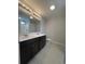 Bright bathroom with double sink vanity, a large mirror, a tiled floor, and a separate shower area at 910 Padgett Lane, Conway, SC 29526