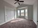 Bedroom with large windows, ample natural light, carpeted floors and a ceiling fan at 910 Padgett Lane, Conway, SC 29526
