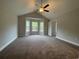 Spacious main bedroom features carpet, a ceiling fan, a vaulted ceiling and a bay window with a wooded view at 910 Padgett Lane, Conway, SC 29526