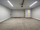 Clean and spacious two car garage featuring concrete flooring, ample lighting, and an electric door opener at 910 Padgett Lane, Conway, SC 29526