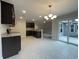 Stylish kitchen with dark cabinets, granite countertops, tile flooring, stainless steel appliances, and natural light at 910 Padgett Lane, Conway, SC 29526