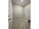 Functional laundry room with tile flooring, wire shelving, washer hookups, and a clean, organized layout at 910 Padgett Lane, Conway, SC 29526