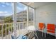 Cozy balcony features bright colored seating around a glass table overlooking neighborhood at 9581 Shore Dr. # 132, Myrtle Beach, SC 29572