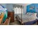 Comfortable bedroom with a wrought iron bed, stylish decor and a coastal view on TV at 9581 Shore Dr. # 132, Myrtle Beach, SC 29572