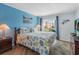 Cozy bedroom with balcony access, wood-look floors, comfy furnishings, and relaxing coastal decor at 9581 Shore Dr. # 132, Myrtle Beach, SC 29572