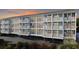 Coastal condo building featuring private balconies, blue facade, and parking underneath, set against a vibrant sunset at 9581 Shore Dr. # 132, Myrtle Beach, SC 29572