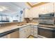 Well-maintained kitchen with stainless appliances, white cabinets, and an open layout that connects to the living area at 9581 Shore Dr. # 132, Myrtle Beach, SC 29572