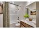 Bathroom featuring shower-tub combo, vanity with bronze faucet and hardware, decorative shower curtain, and stylish decor at 4009 Braid Ct., Myrtle Beach, SC 29588
