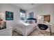 Well-lit bedroom with a teal velvet headboard and decor, accompanied by a desk and chair at 4009 Braid Ct., Myrtle Beach, SC 29588