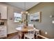 Charming breakfast nook with a round table, white chairs, and a window seat beneath a decorative light fixture at 4009 Braid Ct., Myrtle Beach, SC 29588