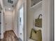 Hallway with wood floors, leading to a mud room niche, and a view of the open floor plan, showcasing bright and airy spaces at 4009 Braid Ct., Myrtle Beach, SC 29588
