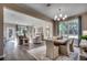 Open-concept living and dining area with hardwood floors, bright windows, and comfortable seating arrangement at 8644 Farrier Dr., Myrtle Beach, SC 29588