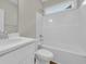 Bright bathroom features a white shower-tub combo, matching sink, and a window for natural light at 2588 Lake Vista Dr., Little River, SC 29566
