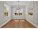 Sunny dining area with wood floors and large windows providing ample natural light and outdoor views at 2588 Lake Vista Dr., Little River, SC 29566