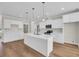 Bright kitchen with white cabinetry, island with sink, and stainless steel appliances for modern convenience at 2588 Lake Vista Dr., Little River, SC 29566