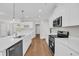 Modern kitchen featuring white cabinetry, quartz countertops, and stainless steel appliances for a clean, sleek design at 2588 Lake Vista Dr., Little River, SC 29566