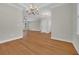 Spacious living room with hardwood floors, light walls, crown molding, and natural light at 2588 Lake Vista Dr., Little River, SC 29566
