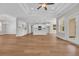 Open floor plan living room with hardwood floors, kitchen, breakfast bar, and backyard views at 2588 Lake Vista Dr., Little River, SC 29566