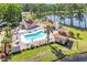 Aerial view of a pool area with lounge chairs, tables, umbrellas, and well-manicured landscaping at 2588 Lake Vista Dr., Little River, SC 29566