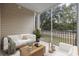 This screened porch has beige walls, furniture, decor, a light ceiling fan, and a road view at 627 Bonaventure Dr. # 202, Myrtle Beach, SC 29577