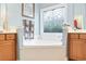 Bright bathroom featuring a large bathtub beneath a decorative window at 1066 Brentford Pl., Myrtle Beach, SC 29579