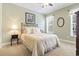 Cozy bedroom featuring a neutral color scheme, a window, and a comfortable bed with decorative pillows at 1066 Brentford Pl., Myrtle Beach, SC 29579