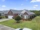 Expansive brick home with lush landscaping and a sprawling lawn for outdoor enjoyment at 1066 Brentford Pl., Myrtle Beach, SC 29579