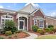 Charming brick house with a manicured front lawn and a curved walkway at 1066 Brentford Pl., Myrtle Beach, SC 29579
