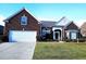 Charming red brick home with a well-manicured lawn and a spacious two-car garage at 1066 Brentford Pl., Myrtle Beach, SC 29579