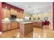 Spacious kitchen with a center island, modern appliances, and wooden cabinets, open to living areas at 1066 Brentford Pl., Myrtle Beach, SC 29579