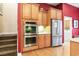 Gourmet kitchen with built-in stainless steel double ovens and refrigerator with stairs to the left at 1066 Brentford Pl., Myrtle Beach, SC 29579