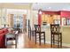 Open concept living area with bar seating separating kitchen and dining spaces and an open living area at 1066 Brentford Pl., Myrtle Beach, SC 29579