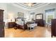 Main bedroom with hardwood floors, crown molding, lots of furniture and natural light streaming through the windows at 1066 Brentford Pl., Myrtle Beach, SC 29579
