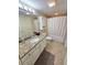 Neutral-toned bathroom with tub and shower combo, granite vanity, and storage at 2007 S Ocean Blvd. # 401, Myrtle Beach, SC 29577