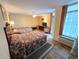 Bright bedroom featuring two beds, wood-look floors, a ceiling fan, and a sliding glass door at 2007 S Ocean Blvd. # 401, Myrtle Beach, SC 29577