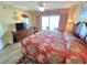 Inviting bedroom boasts balcony access, wood-look flooring, and lots of natural light at 2007 S Ocean Blvd. # 401, Myrtle Beach, SC 29577