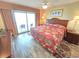 Relaxing bedroom featuring balcony access, wood-look flooring and a spacious closet at 2007 S Ocean Blvd. # 401, Myrtle Beach, SC 29577