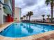 Outdoor pool area with palm trees, lounge chairs, and ocean views at 2007 S Ocean Blvd. # 401, Myrtle Beach, SC 29577